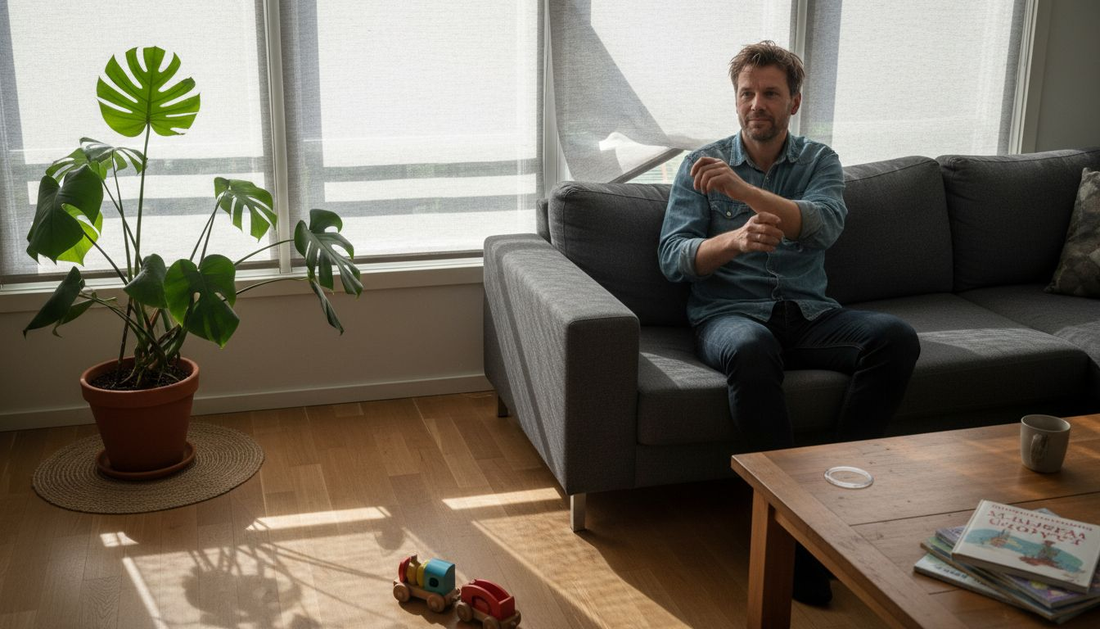 Mies säätää sälekaihtimia valoisassa olohuoneessa.